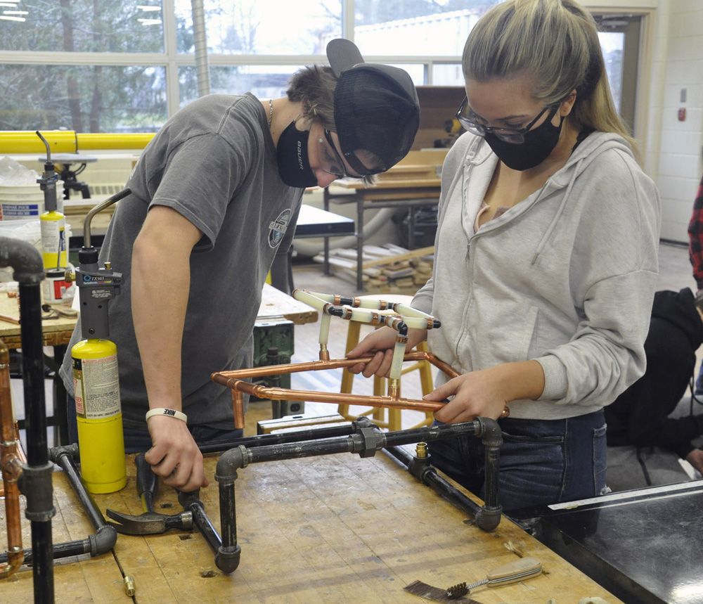 Certified plumbing instructor visits high school for handson approach