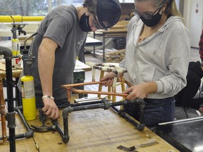 MDHS Construction students Tristan Maiert (left) and Alyssa Priestap work together on their dual credit plumbing unit Nov. 16. ANDY BADER/MITCHELL ADVOCATE