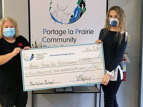 PCRC community facilitator, Rachel Templeton (left) presents Prairie Fusion's executive director Stephanie McKim with the grant. (supplied photo)