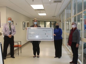 Paul Chatelain, Chief Executive Officer of the MICs Group  and Jennifer Emond, Director of Care at Villa Minto, gratefully accept a cheque from Cecile Johnson and Kathy Bond-Johnson  on behalf of RTOERO for the purchase of a  omiVista Mobii Magic Table – Interactive Projection System. TP.JPG