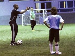 Coach Aziz Almuwallad, of the boys' U13 rep team from the Greater Sudbury Soccer Club, goes through a drill with players during a practice at the soccer centre in Sudbury, Ont. on Saturday April 18, 2015.
