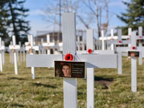 In recognition of the Canadian soldiers who died in the war in Afghanistan, 152 crosses have been placed in front of the Nose Creek Valley Museum's Light Armoured Vehicle. Photo by Kelsey Yates