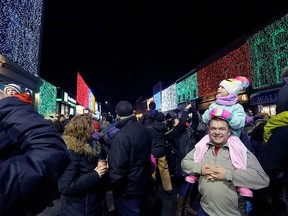 Jayme Shelley and his daughter Jane marvel at the lights in downtown Napanee as the town flipped the switch on the Big Bright Lights on Nov. 16, 2018. Due to the COVID-19 pandemic, the municipality will quietly turn on the downtown light show on Nov. 12 this year, forgoing the popular annual street party that usually draws thousands of spectators. MEGHAN BALOGH/POSTMEDIA STAFF
