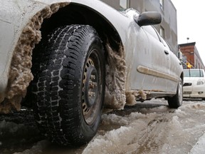 Icy slush fills the wheel wells and tire treads of a car in Trenton during a storm Dec. 21, 2013. Police recommend vehicles use four snow tires and that drivers not only drive according to conditions but also prepare for emergencies, such as being stranded.