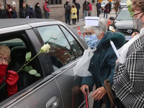 It was a busy morning in Market Square Saturday, as the public, Belleville council, EMS workers and former colleagues from Belleville General Hospital of Pat Culhane bid her farewell. Ms. Cuhabe died Nov. 8 and pictured is her sister Anne Bunnett accepting a rose from former emergency nurse ??? (centre) and R.N. Diane Smith. BRUCE BELL