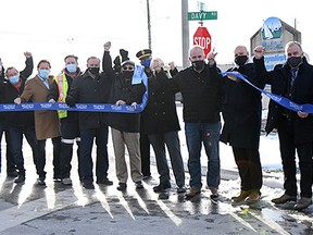 The City of Belleville cut the ribbon to mark the completion of Phase 2 of the Bell Boulevard widening project Tuesday. Pictured from the left are: Ray Ford, Stan Czyczyro, (Marcel Philippe, Brent Barr, Bert Barr, Jordan Barr Ð from Barr Construction), Rod Bovay, Councillor Garnet Thompson, Deputy Fire Chief Paul Patry, Councillor Bill Sandison, Bay of Quinte MPP Todd Smith, Mayor Mitch Panciuk, Bay of Quinte MP Neil Ellis, Stephen Ashton and Joe Reid.