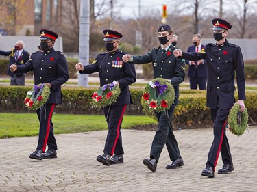 Members of the 56th Field Regiment, Royal Canadian Artillery (from left) Gunner Dominyck Alonso, Sgt. Grant Philpott, Gunner Ty Shamblin and Sgt. Travis McLaughlin march toward the Brant County War Memorial on Dalhousie Street in downtown Brantford to lay wreaths on Wednesday morning.Brian Thompson/Brantford Expositor/Postmedia Network