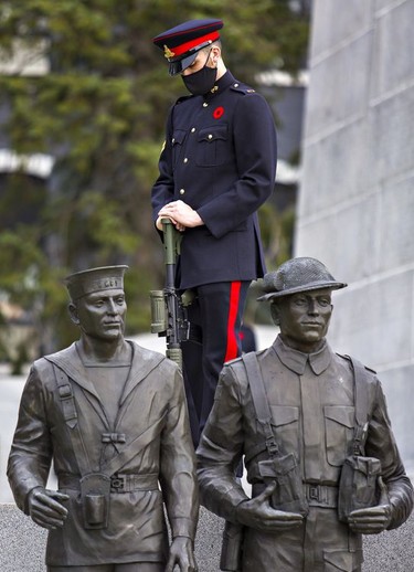 Wearing a Royal Canadian Artillery dress uniform, a member of the 56th Field Regiment stands sentry at the Brant County War Memorial in downtown Brantford on Wednesday morning. Brian Thompson/Brantford Expositor/Postmedia Network