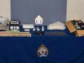 Brantford Police seized more than $165,000 and a restricted weapon following an investigation at a Wayne Drive home in Brantford on Friday.