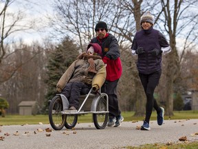 Peter Eaton (right) of Toronto nears the end of his 42.5-kilometre marathon on the Sixth Concession, near Burford, where he was joined by his father, Clayton, and sister Emily. Eaton ran his first marathon on his 42nd birthday as a fundraiser for the ARCH Disability Law Centre, an organization that represented his sister, who has cerebral palsy, decades ago challenging a school board's decision to put her in a segregated classroom.