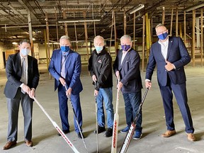Kevin Finney (left), Brantford director of economic development, Brantford Mayor Kevin Davis, Heritage Hockey Sticks owner W. Graeme Roustan, Brantford-Brant MP Phil McColeman and Brantford-Brant MPP Will Bouma pose for a photo in the soon-to-be new home of the hockey stick manufacturer at 11 Spalding Dr.