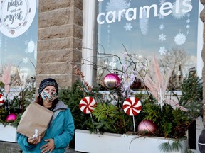 Holding a bag of goodies and clutching a free sea salt carame,l Deb Decairos-Granmaitre poses in front of Pickle and Myrrh in Merrickville. The gifted caramel she said really brightened her day and reminded her how much fun it is to give.