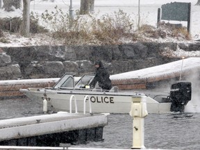 An officer prepares to bring an Ontario Provincial Police boat back to shore Sunday afternoon in Brockville, after police recovered the remains of a missing diver from the St. Lawrence River. (RONALD ZAJAC/The Recorder and Times)
