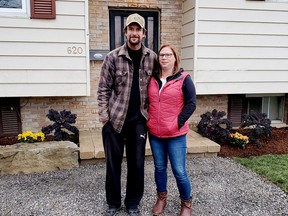 Thrilled with the makeover, Alexis Wakelin poses with her partner Roger Foley in front of the new front step and expanded flowerbed.(HEDDY SOROUR/Local Journalism Initiative)