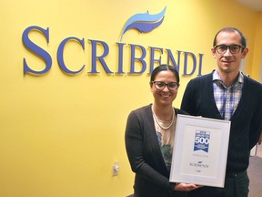 Scribendi president Patricia Riopel and CEO Enrico Magnani hold up their award for making the Growth 500 Canada's Fastest Growing Companies list in Canadian Business magazine at their Chatham office in 2018. The company has made the list again in 2020. Canadian Executive Search Group, another Chatham business, also made the list.