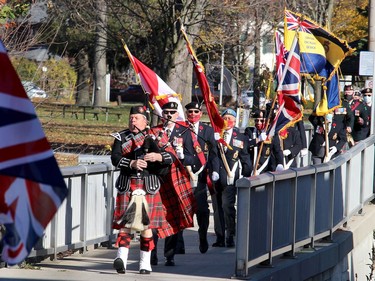 Piper Walter Tomaszewski leads the Royal Canadian Br. 642 Colour Guard procession over the Sixth Street Bridge to begin the Remembrance Day service held at the cenotaph in downtown Chatham on Wednesday.
Ellwood Shreve/Chatham Daily News/Postmedia