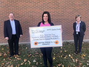 Handout/Chatham Daily News Nicole Paquette, middle, of Noelle's Gift foundation, presents a $125,000 cheque to John Howitt, director of education, Lambton Kent District School Board and Deb Crawford, director of education, St. Clair Catholic District School Board on Thursday.