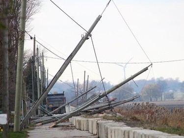 Several hydro poles along Erie Shore Drive were snapped by powerful winds that also caused flooding. The aftermath of the damage from the snapped hydro poles remained on Monday after the water had subsided. Ellwood Shreve/Chatham Daily News/Postmedia Network