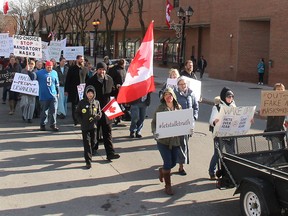 Protesters opposed to COVID-19 restrictions marched through downtown Chatham on Nov. 21. (Ellwood Shreve/Chatham Daily News)