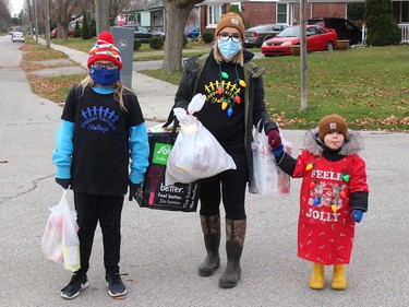 Mattea Marchand, 9, Brooke Shepherd andLiam Shephered, 3, helped collect donations of toys and food for The Gift C-K event held across Chatham-Kent in Saturday, November 21, 2020. Ellwood Shreve/Chatham Daily News/Postmedia Network