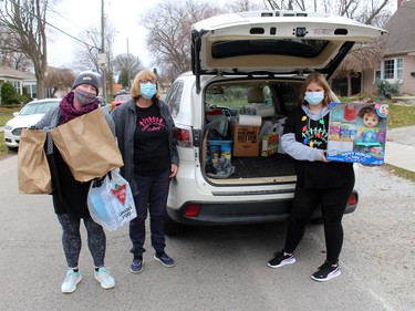 Mindy Bowls, left, Myrna Panjer and Julia Snelgrove, 13, were busy collecting donations of food and toys during The Gift CK event held across Chatham-Kent on Saturday November 21, 2020. Ellwood Shreve/Chatham Daily News/Postmedia Network