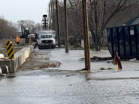 A crew works on the dike on Erie Shore Drive, near Erieau,  Thursday as the area is under a flood warning issued by the Lower Thames Valley Conservation Authority due to strong winds. Ellwood Shreve/Chatham Daily News/Postmedia Network