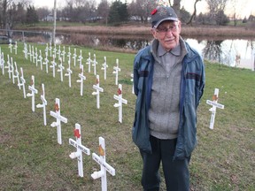 Second World War veteran Les Foulds, 100, of Cornwall, near the crosses - including ones in memory of his father Gordon and brother Albert - placed at the site of the future Martintown Cenotaph. Photo on Tuesday, November 10, 2020, in Martintown, Ont. Todd Hambleton/Cornwall Standard-Freeholder/Postmedia Network