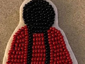 Red dress pins, created by local Cree designer Cree-ative Designs, are being used to raise awareness for Missing and Murdered Indigenous Women and Girls. Photo Supplied.