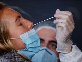 A health worker administers a nasal swab to a patient. File photo