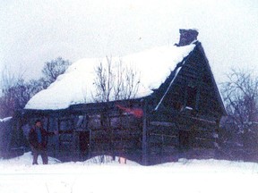The Gunsinger family's log house near Plevna as it looked 50 years ago with the author's late brother Ted in the foreground. (Frank Kennedy/Supplied Photo)