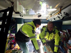 Frontenac Paramedics' Terry Baker, left, and Dave Doran sort toys at the 2019 holiday toy drive at Toys 'R' Us in Kingston, organized by members of Ontario Public Sector Employees Union Local 462 and staff of the Kingston Area Communication Centre. This year's toy drive is to be an online fundraising effort.