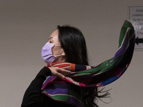 Chief financial officer of Huawei, Meng Wanzhou, flicks her scarf over her shoulder as she arrives at B.C. Supreme Court in downtown Vancouver on Oct. 29. A judge has ruled that lawyers for Meng Wanzhou can argue the United States misled Canadian officials in a win for the Huawei executive. (Jonathan Hayward/The Canadian Press)