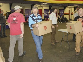 An army of volunteers spent the day helping packing 25,000 food hampers for the 2014 Jerome Taylor Memorial Whig-Standard/Salvation Army Christmas Hamper Fund at the Princess of Wales Own Regiment parade square in Kingston on Dec. 17, 2014.
