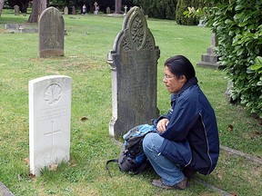 John Chookomolin's final resting place is in St Jude's Cemetery in Englefield Green, UK, a small community on the outskirts of the city of London, England. Here we see Xavier Kataquapit at the grave of his great grandfather during a visit to England.
