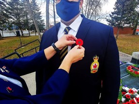 Legion 87 Comrade Joel Brisson has his poppy checked just prior to this year's Remembrance Day service.