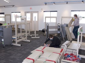 Volunteers, board members and library staff have been busy getting the shelves put up at the Mayerthorpe Library's new location. L-r, Ruth Anderson, retired library assistant; Darsi Hall (sitting), assistant librarian; and Shelley Bannister, board vice chair.
Brigette Moore