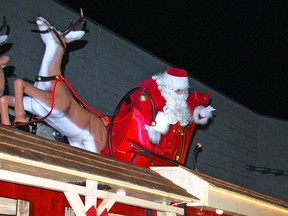 Santa Claus waves at children in a car Saturday night during the 75th annual Kiwanis Owen Sound Santa Claus Parade, which was held as a drive-through event for 2020 in the Harry Lumley Bayshore Community Centre's parking lot due to the COVID-19 pandemic. DENIS LANGLOIS