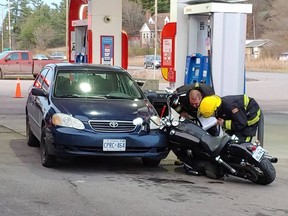 Township of Laurentian Valley firefighters inspect the motorcycle and the parked vehicle it collided with after its driver was ejected in a collision with another vehicle in a crash on Highway 148/Greenwood Road Thursday afternoon. Anthony Dixon