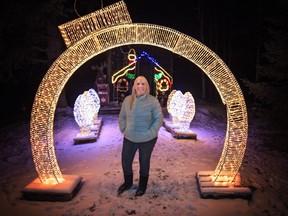 Gwen Dionne poses under the new ornament arch that will be on display for all to enjoy at her Woodlands County acreage. 
Brigette Moore