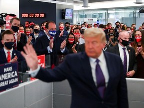 U.S. President Donald Trump's campaign staff applaud him as he waves after speaking to them while visiting his presidential campaign headquarters on Election Day outside of Washington in Arlington, Va., on Nov. 3. (Tom Brenner/Reuters)
