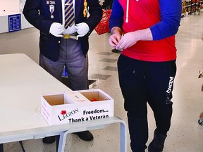 LEST WE FORGET: Former air cadet Matias Sousa purchases a poppy from Alan Platt of Branch 25, Royal Canadian Legion – at a distance – while picking up a few groceries at the Northern Avenue Metro. A few of the larger stores in town have poppy taggers this year, but not the usual number of honour boxes. Poppies are available through the branch until Nov. 10. Shoppers can watch for poppy displays at local businesses and at James L. McIntyre Centennial Library, 50 East St. See story on Page 2. ALLANA PLAUNT/SAULT THIS WEEK