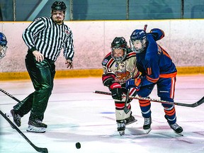 Jared Dupuis of the Blind River Beavers and Tyson Doucette of the Soo Thunderbirds chase the puck in NOJHL exhibition action from this past weekend. BOB DAVIES