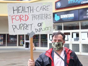 Alessandro Presenza takes part in a protest organized by the Sudbury chapter of the Ontario Health Coalition, in Sudbury on June 24