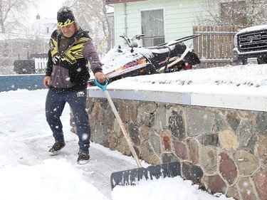 Louis Chretien clears snow from his driveway in Sudbury, Ont. on Monday November 2, 2020. Environment Canada said Greater Sudbury can expect  a 40 per cent chance of flurries in the afternoon with a high of -2 C on Tuesday. John Lappa/Sudbury Star/Postmedia Network