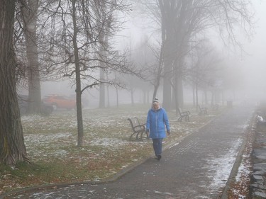A woman goes for a walk as a thick blanket of fog covers the landscape in Sudbury, Ont. on Wednesday November 4, 2020. John Lappa/Sudbury Star/Postmedia Network