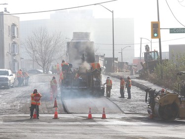 Steam rises off asphalt while workers pave Frood Road near College Street in Sudbury, Ont. on Wednesday November 4, 2020. John Lappa/Sudbury Star/Postmedia Network