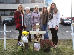 Family members of the late Myles Keaney gathered at the site where he was found in front of the Van Horne Street fire hall on Sept. 8, 2020. Keaney's sisters, Christina Pisanti, left, Brittney Sandul, Lindsey Melanson, and grandmother Aline Pitcher and his mom, Denise Sandul, middle, stand near crosses, including Keaney's, that were erected in memory of people who died of an overdose.