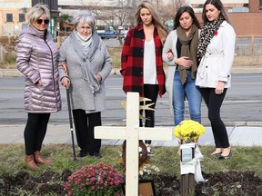 Family members of the late Myles Keaney gathered at the site where he was found in front of the Van Horne Street fire hall in Sudbury, Ont. on September 8, 2020. Keaney's mom, Denise Sandul, left, grandmother Aline Pitcher, and sisters, Christina Pisanti, Brittney Sandul and Lindsey Melanson stand near crosses, including Keaney's, that were erected in memory of people who died of an overdose.