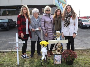Family members of the late Myles Keaney gathered at the site where he was found in front of the Van Horne Street fire hall. Keaney's sisters, Christina Pisanti, left, Brittney Sandul and Lindsey Melanson; along with his grandmother, Aline Pitcher; and his mom, Denise Sandul, middle, stand near crosses that were erected in memory of people who died of an overdose.