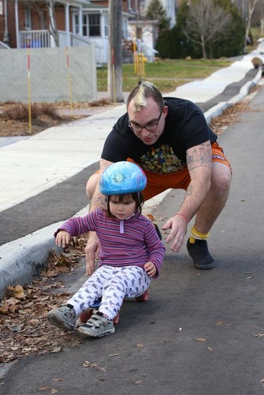 Adeline Gareau, 2, works on her skateboarding technique with the help of her father, Chad, in Sudbury, Ont. on Tuesday November 10, 2020. John Lappa/Sudbury Star/Postmedia Network